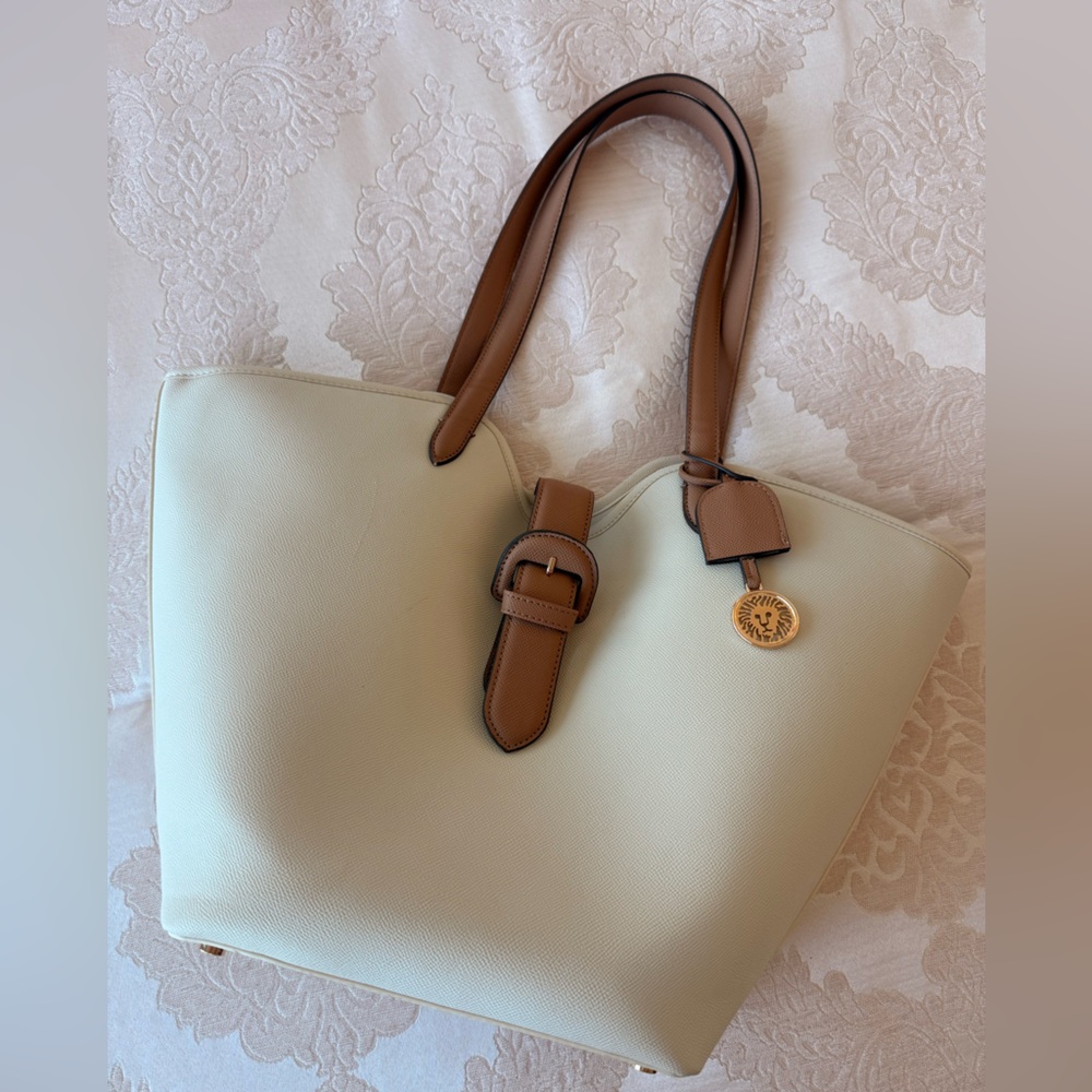 Cream tote bag with brown accents.